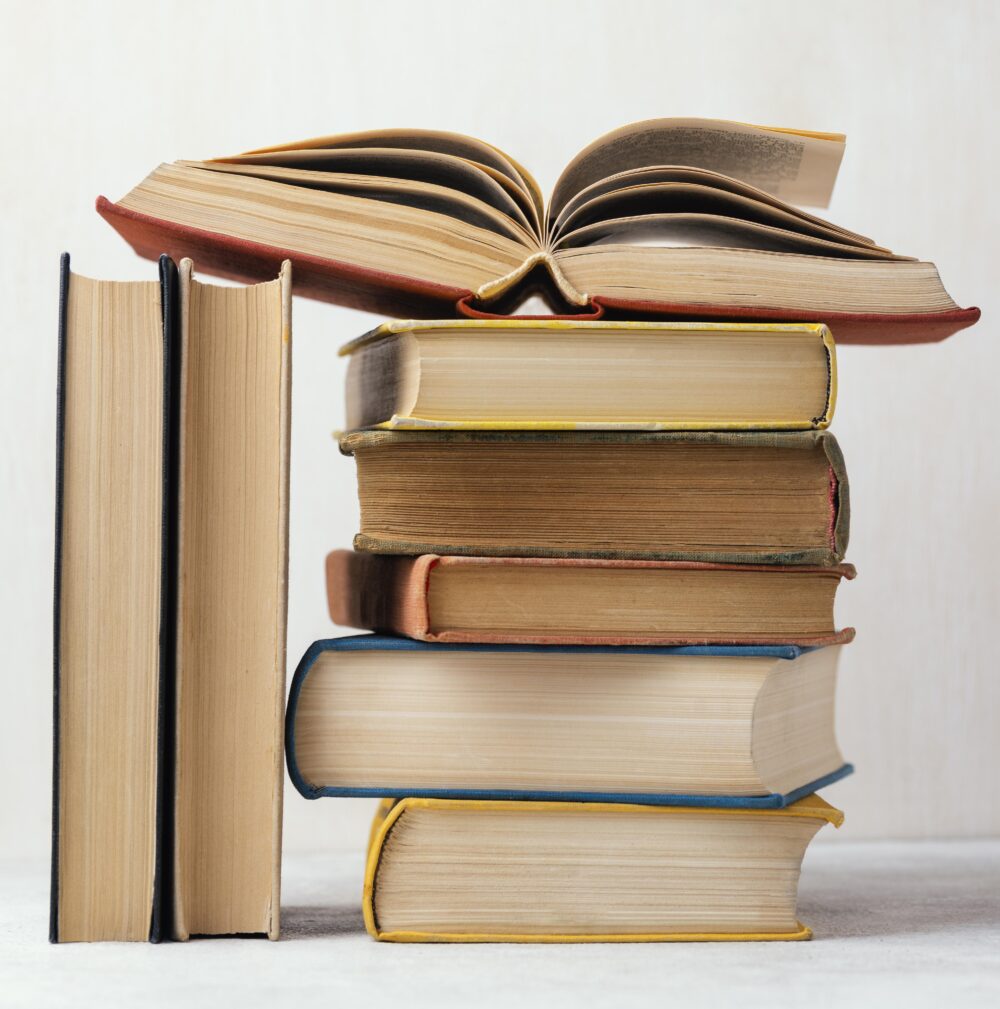 vue avant de la pile de livres avec un ouvert e1753173695419